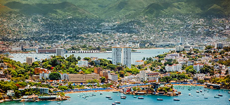 Mountains and building clustered around Acapulco bay in Mexico