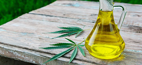 Cannabis cooking oil in a pitcher on a picnic table