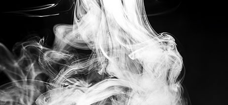 White smoke swirling on a black background