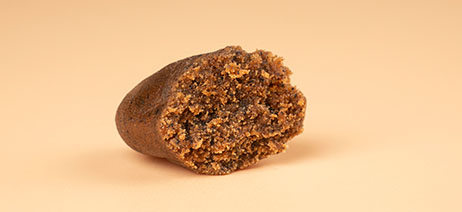 Half of a brick of hash on an orange background