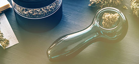 Glass marijuana hand pipe with flower in the bowl