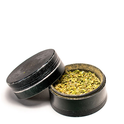 Cannabis grinder with ground flower inside