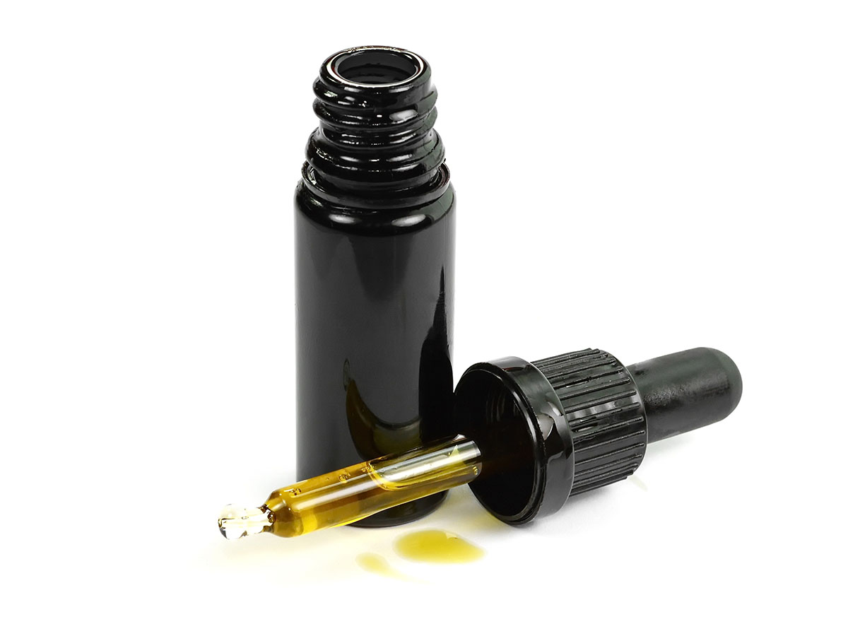 Opaque tincture bottle with the dropper laying next to it