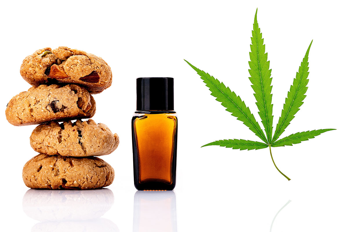 Stack of three cookies, next to a tincture bottle, next to a cannabis leaf