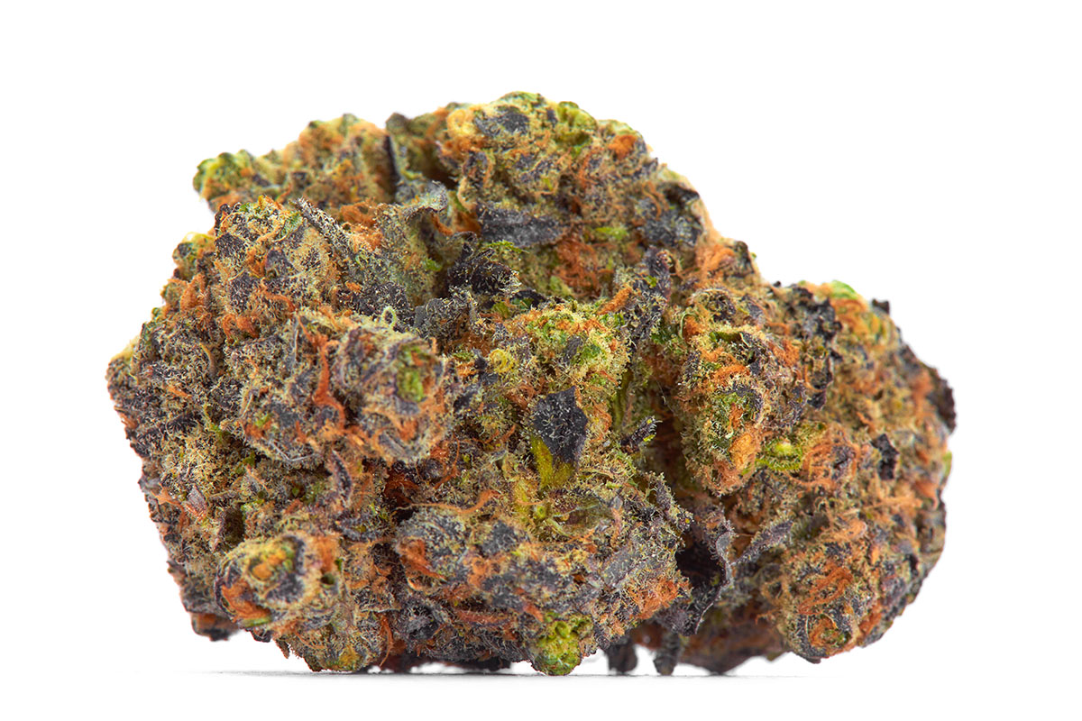 Macro shot of a green, purple, and orange cannabis bud