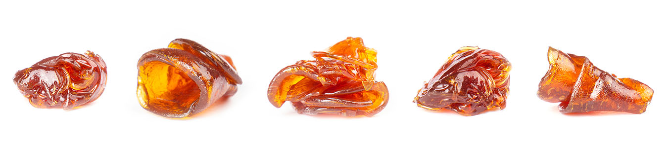 Five balls of live resin sitting in a line on a white background