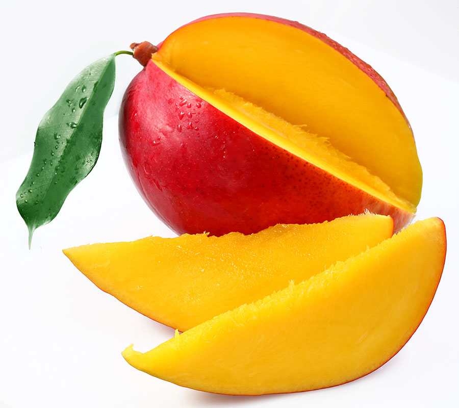 Mango with two slices cut out, both sitting in front of the mango