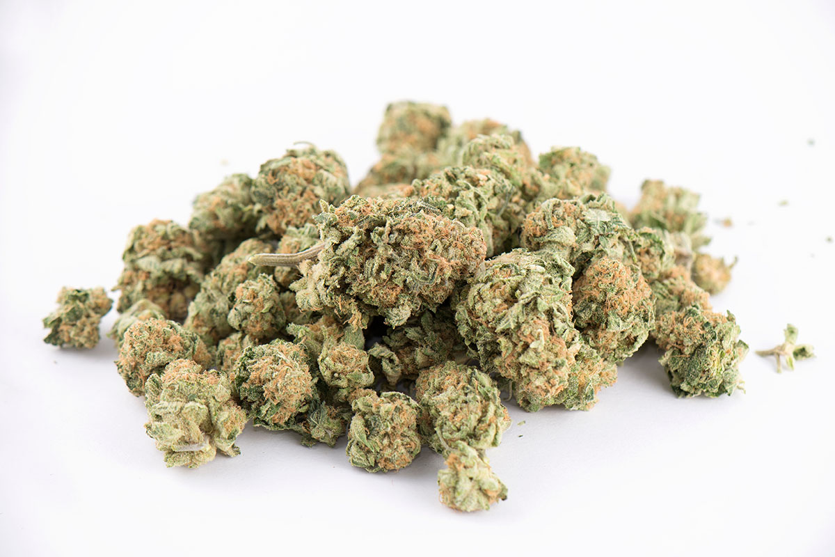 an ounce of marijuana flower on a white background