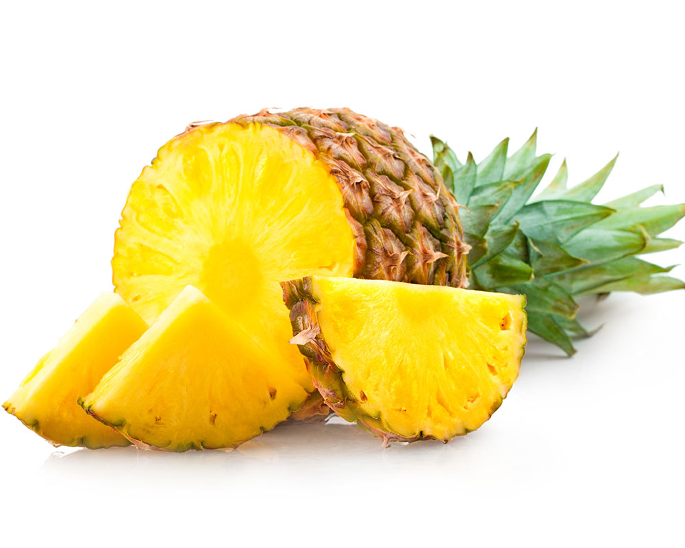 Half a pineapple and pineapple slices