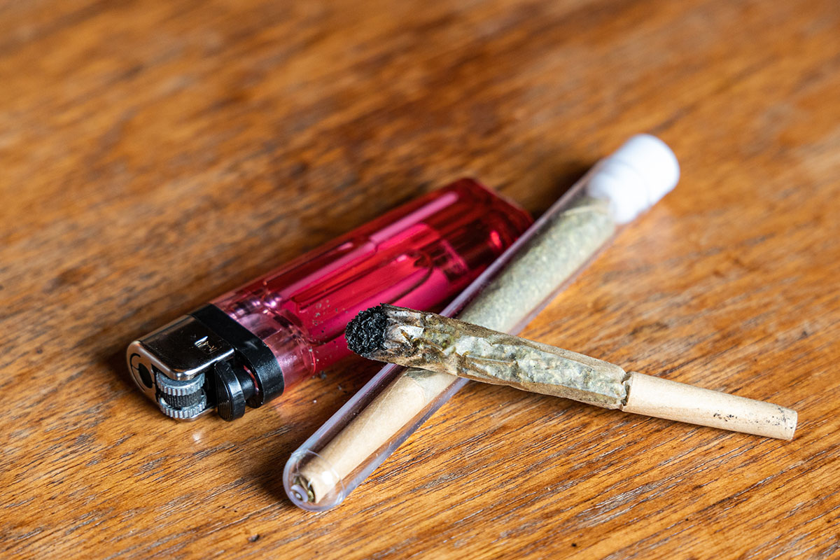Joint in a tube next to a lighter