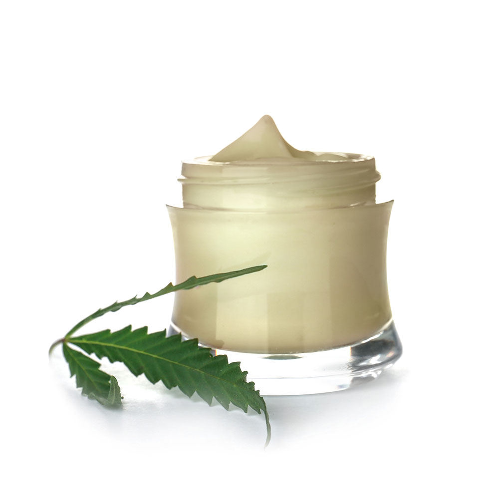 THC face cream in a clear, open cosmetics bottle, with a cannabis leaf in front